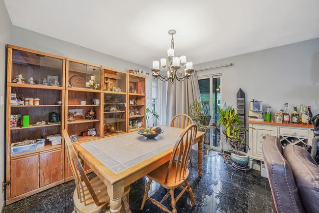 Dining space with granite tiled floors and a chandelier | Image 10