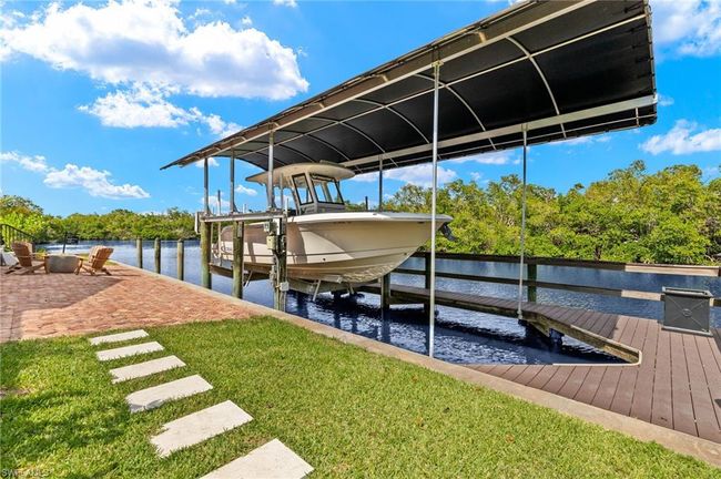 Dock area featuring a yard, a water view, and boat lift | Image 46