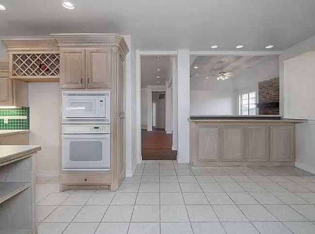 Kitchen with white appliances, recessed lighting, ceiling fan, and light tile patterned flooring | Image 7