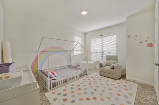 Carpeted bedroom featuring baseboards and a crib | Image 17