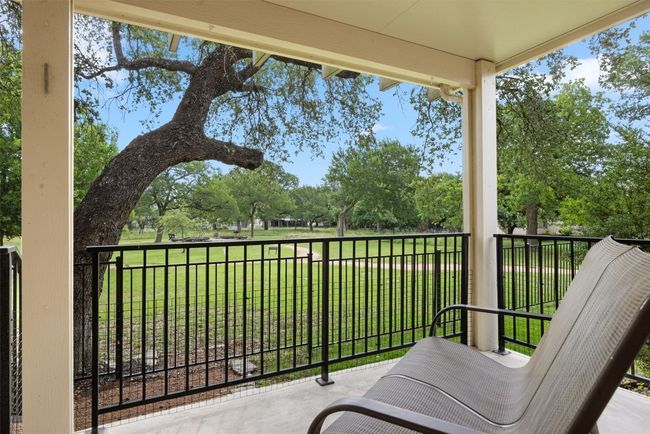 Balcony featuring view of scattered trees | Image 25