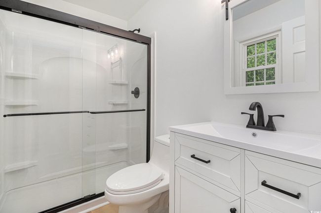 Primary Bathroom featuring a walk-in shower and small window for lots of natural light. LED light exhaust fan has WIFI capability to enjoy music or your favorite podcast while you shower! | Image 22