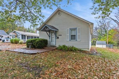 View of front of home featuring a cute entry, front lawn, landscaping, mailbox and shutters | Image 2