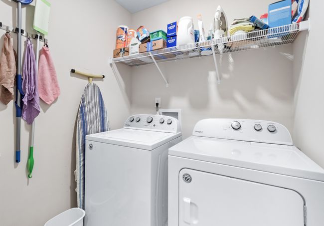 Laundry room has a handy shelf and a rack to store cleaning items. | Image 21