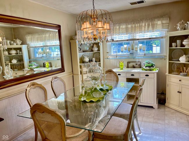 dining space featuring a chandelier and plenty of natural light | Image 25