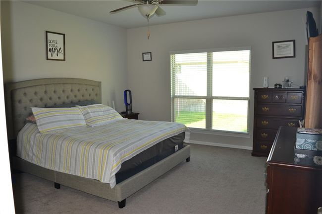 Bedroom featuring carpet, multiple windows, baseboards, and a ceiling fan | Image 15