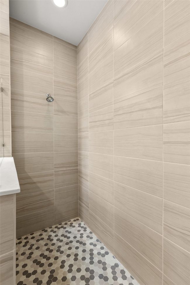 Bathroom featuring a tile shower | Image 22