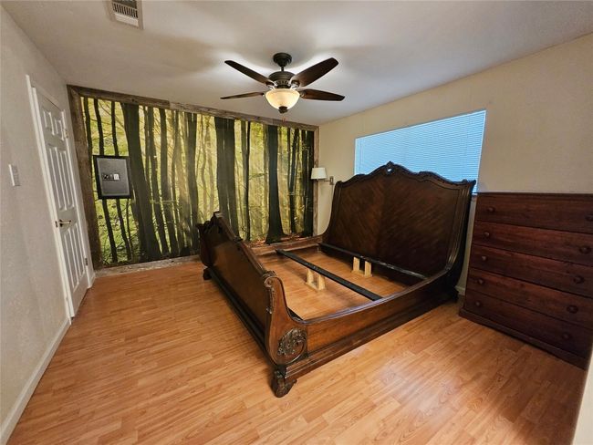 Bedroom featuring wood finished floors and a ceiling fan | Image 11