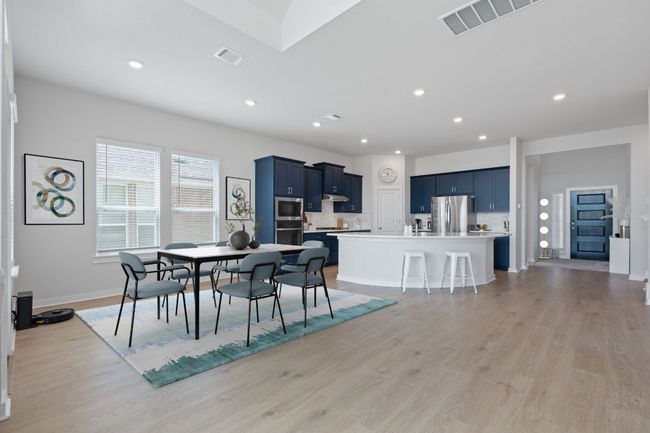 Dining room with baseboards, visible vents, light wood-type flooring, and recessed lighting | Image 14