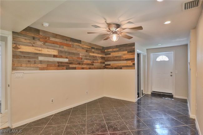 Entryway featuring wooden walls, a ceiling fan, baseboards, and recessed lighting | Image 13