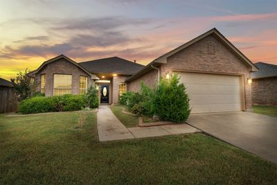 View of front of house featuring a lawn and a garage | Image 2