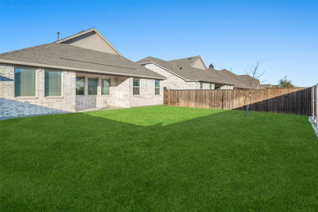 Back of property featuring roof with shingles and brick siding | Image 24