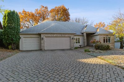 This stately brick front rambler has 4 bd / 3 bath and is located on a quiet street within the 196 school boundary. The paver driveway and circular birdbath area that were added in 2007 add to the stunning curb appeal of this home. | Image 1