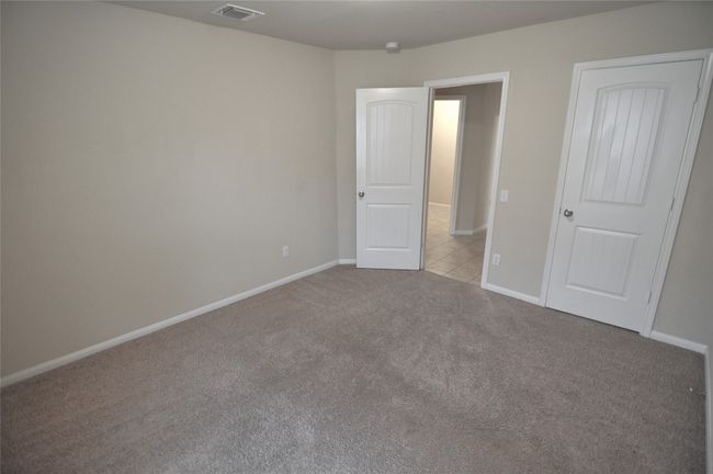 Unfurnished bedroom featuring visible vents, carpet flooring, and baseboards | Image 8