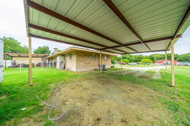 View of green lawn with a carport | Image 5