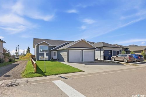 Contemporary exterior with blue siding, a two-car garage, and a concrete driveway | Card Image