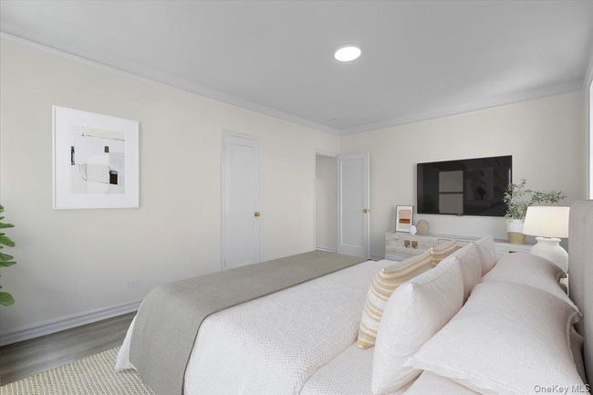 Bedroom featuring crown molding and wood finished floors | Image 11