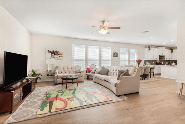Living room featuring recessed lighting, visible vents, light wood-style flooring, a ceiling fan, and baseboards | Image 5