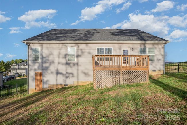 View of the Back of the Home showing the Door to the Crawl | Image 35