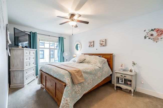 Bedroom with carpet flooring, ceiling fan, and baseboards | Image 22