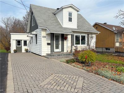 Welcome to 135 Peter St.! The lovely interlock drive adds to the curb appeal for this updated 3 bed and 2 bath home. | Image 1