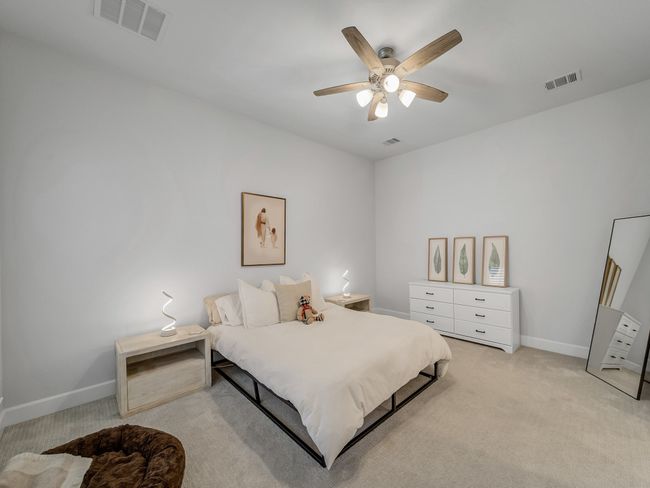 Bedroom with light colored carpet and a ceiling fan | Image 19