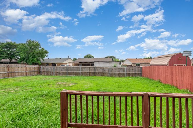 Fenced backyard with a residential view | Image 20