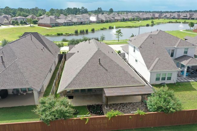 Drone Shot of Entire Property, Showing Lake in Front of House and Greenbelt in Back. NO NEIGHBORS in Front or Behind House. This was a PREMIUM Lot at Time of Building. | Image 34