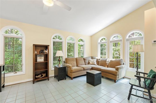 Living area featuring vaulted ceiling, light tile patterned flooring, and a ceiling fan | Image 20