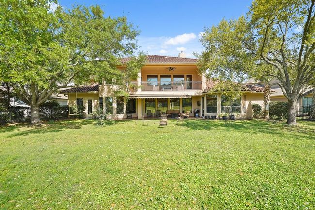 A view of the back of the home, covered patio with extended awning and the many windows providing so much natural light into the home. | Image 47