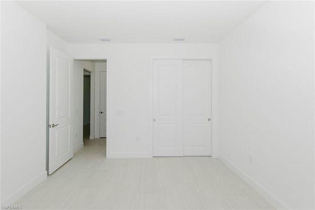 Unfurnished bedroom featuring baseboards and a closet | Image 5