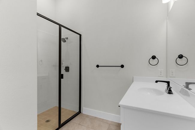 Bathroom featuring tile patterned flooring, a stall shower, vanity, and baseboards | Image 27