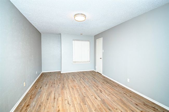 Empty room featuring light wood-type flooring and a textured ceiling | Image 20