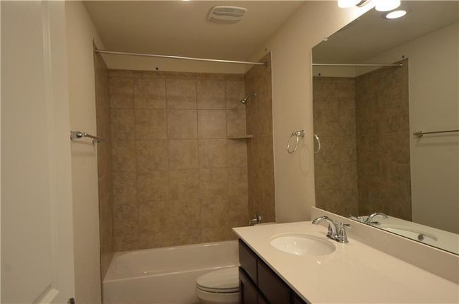 Bathroom with vanity and bathtub / shower combination | Image 21