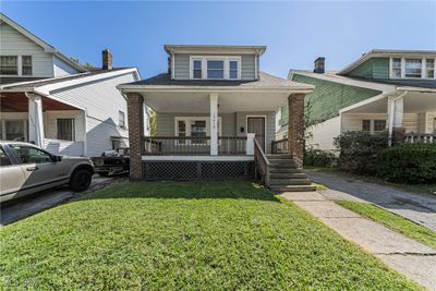 Bungalow-style home with a porch and a front lawn | Image 1