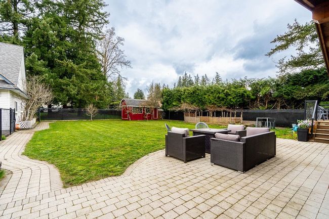 View of patio / terrace featuring outdoor lounge area, an outbuilding, a fenced backyard, and a storage shed | Image 35