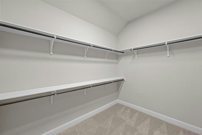 A generous walk-in closet provides ample storage and organization for clothing and accessories. | Image 20