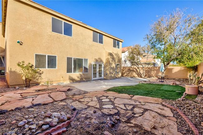 Back of house with french doors, a fenced backyard, a patio, and stucco siding | Image 44