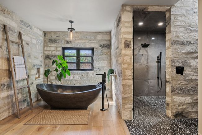 Bathroom featuring wood finished floors, a freestanding bath, a walk in shower, and french doors | Image 26