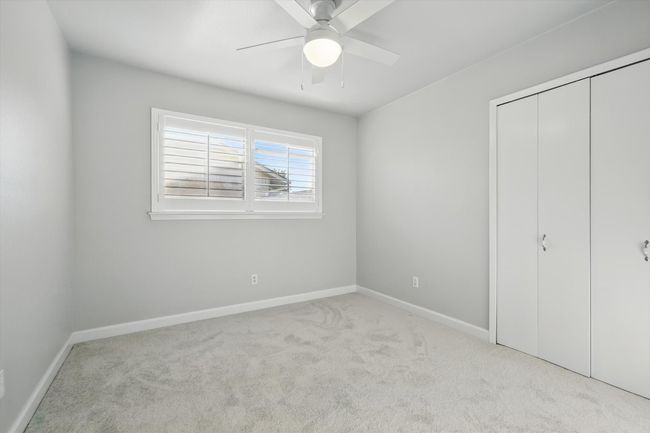 Unfurnished bedroom featuring baseboards, carpet floors, a closet, and ceiling fan | Image 27