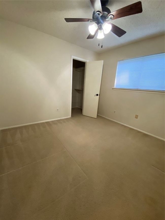 Unfurnished bedroom featuring a closet, baseboards, ceiling fan, a textured ceiling, and carpet floors | Image 24