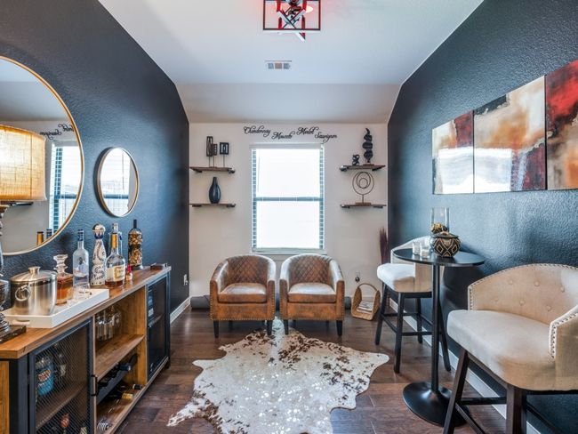 Sitting room featuring dark wood-style floors, lofted ceiling, a textured wall, and visible vents | Image 8