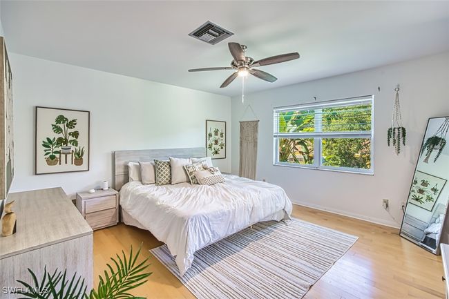 Bedroom featuring light wood-type flooring and a ceiling fan | Image 19