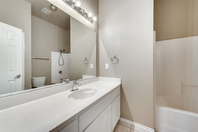 Bathroom featuring vanity, tile patterned floors, and shower combination | Image 22