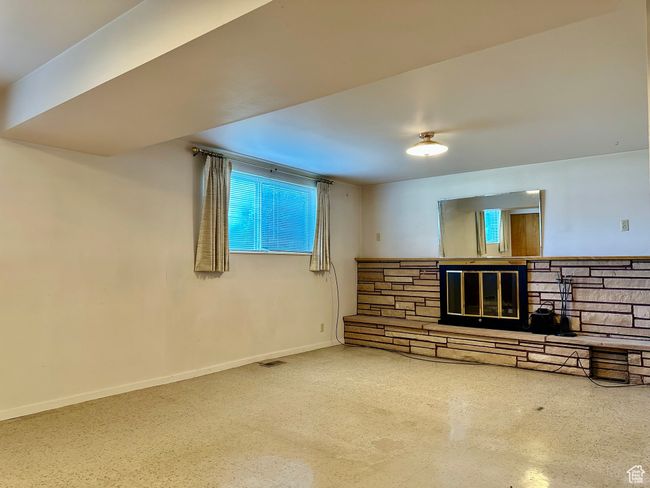 Family room with healthy amount of natural light and a fireplace | Image 15