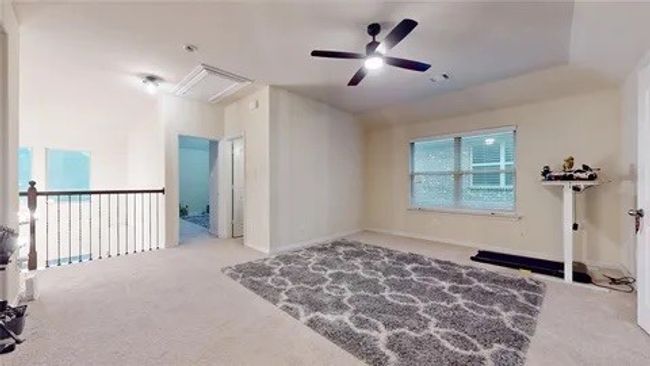 Unfurnished room with carpet flooring, attic access, and ceiling fan | Image 8