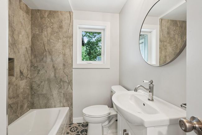 1st fl Full bath, vanity, tub /shower combination, and tile patterned floors | Image 12