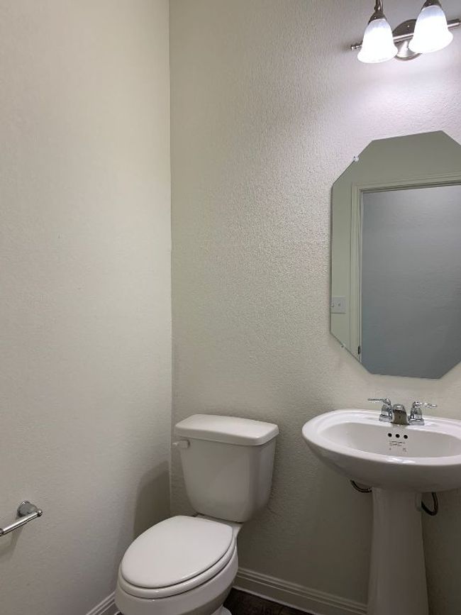 Bathroom featuring toilet and a sink | Image 10