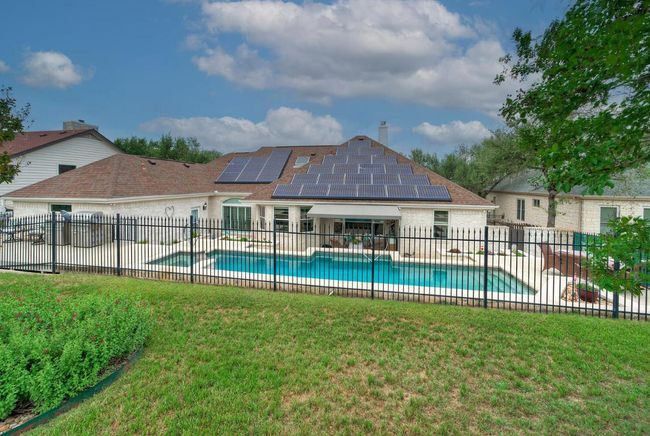 View of swimming pool featuring a patio, a fenced backyard, a fenced in pool, and a lawn | Image 37