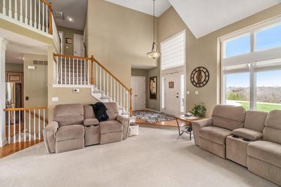 Living room with carpet floors and a towering ceiling | Image 3